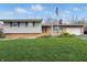 Charming single-story home with brick accents, a lush lawn, and an American flag at 318 Camby St, Greenwood, IN 46142