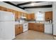 Functional kitchen featuring white appliances, oak cabinetry, and a tiled floor at 318 Camby St, Greenwood, IN 46142