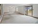 Open living room leading to an outdoor deck with a ceiling fan and carpeted floors at 318 Camby St, Greenwood, IN 46142