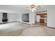 Open-concept living room with fireplace, carpeted floors, and view into the kitchen at 318 Camby St, Greenwood, IN 46142
