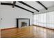 Living room with hardwood floors, a fireplace, large windows, and beamed ceilings at 318 Camby St, Greenwood, IN 46142