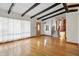 Bright living room with hardwood floors, beamed ceilings, staircase and large windows at 318 Camby St, Greenwood, IN 46142
