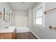 This bathroom features a tub, vanity, and window at 3241 N Capitol Ave, Indianapolis, IN 46208