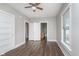 This bedroom features wood-look flooring, bright window, and view into bathroom at 3241 N Capitol Ave, Indianapolis, IN 46208