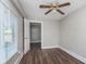 Bright bedroom featuring new laminate floors, a ceiling fan, and two windows at 3241 N Capitol Ave, Indianapolis, IN 46208
