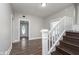 Inviting entryway with wood-look floors, stairs, and a decorative glass front door offering a warm welcome at 3241 N Capitol Ave, Indianapolis, IN 46208