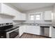 Bright kitchen with white cabinetry, granite countertops and stainless steel appliances at 3241 N Capitol Ave, Indianapolis, IN 46208