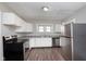 Well-lit kitchen featuring stainless steel appliances, white cabinets, and modern countertops at 3241 N Capitol Ave, Indianapolis, IN 46208