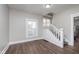 Inviting living room featuring new laminate floors, a staircase, and a window at 3241 N Capitol Ave, Indianapolis, IN 46208