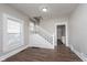 Inviting living room featuring new laminate floors, a staircase, and a window at 3241 N Capitol Ave, Indianapolis, IN 46208