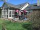 Brick home with covered patio and open yard is perfect for outdoor entertaining at 3504 Inverness Blvd, Carmel, IN 46032