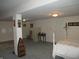Partially finished basement with a bed, storage shelves, and a separate tiled section at 3504 Inverness Blvd, Carmel, IN 46032
