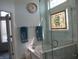 Luxurious bathroom with a glass-enclosed shower, marble accents, and a unique window design at 3504 Inverness Blvd, Carmel, IN 46032