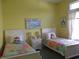 Charming bedroom with bright yellow walls, twin beds and colorful quilt bedding at 3504 Inverness Blvd, Carmel, IN 46032