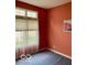 Comfortable bedroom with warm, red walls, carpet flooring, and a window offering natural light at 3504 Inverness Blvd, Carmel, IN 46032
