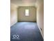 Simple bedroom with blue carpeting, white walls, and a window, ready for customization at 3504 Inverness Blvd, Carmel, IN 46032