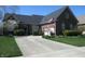 Charming brick home featuring a well-manicured lawn and a spacious driveway leading to the garage at 3504 Inverness Blvd, Carmel, IN 46032