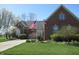 Beautifully landscaped brick home with lush greenery and a welcoming facade on a sunny day at 3504 Inverness Blvd, Carmel, IN 46032