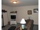 Basement living area with TV on cabinet, decorated shelves, and a comfortable seating area at 3504 Inverness Blvd, Carmel, IN 46032