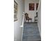 Carpeted stairway with white walls, chair and artwork on the landing providing classic charm at 3504 Inverness Blvd, Carmel, IN 46032