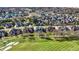 Expansive aerial view of a Primary-planned community surrounding a golf course, with luxury homes and scenic landscaping at 3582 Pete Dye Blvd, Carmel, IN 46033