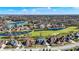 Panoramic aerial view showcasing a vibrant neighborhood surrounding a lush golf course with serene ponds and green spaces at 3582 Pete Dye Blvd, Carmel, IN 46033