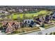 Aerial view of a home and neighborhood next to a golf course and pond in a suburban residential area at 3582 Pete Dye Blvd, Carmel, IN 46033