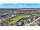 Stunning aerial view of a golf course community featuring beautiful homes and lush green fairways on a bright day at 3582 Pete Dye Blvd, Carmel, IN 46033