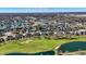 Scenic aerial view of a Primary-planned community with luxury homes surrounding a golf course and sparkling lakes at 3582 Pete Dye Blvd, Carmel, IN 46033