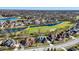 Scenic aerial view of a beautiful suburban neighborhood with homes surrounding a picturesque golf course and ponds at 3582 Pete Dye Blvd, Carmel, IN 46033