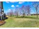 Spacious backyard with a well-maintained lawn and views of surrounding houses and trees at 3582 Pete Dye Blvd, Carmel, IN 46033