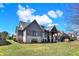 Expansive backyard view showcasing the home's architectural details and lush greenery at 3582 Pete Dye Blvd, Carmel, IN 46033