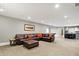 Spacious finished basement features a large sectional sofa and wet bar at 3582 Pete Dye Blvd, Carmel, IN 46033