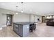 The finished basement features a wet bar, island seating, and stainless refrigerator at 3582 Pete Dye Blvd, Carmel, IN 46033