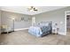 Spacious bedroom with neutral carpeting, a ceiling fan, and decorative art provides a calming retreat at 3582 Pete Dye Blvd, Carmel, IN 46033