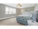 Bright bedroom features a large window, neutral carpeting and light gray walls for a serene atmosphere at 3582 Pete Dye Blvd, Carmel, IN 46033