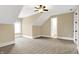 Neutral bedroom with carpet, a ceiling fan, and a doorway leading to a bathroom at 3582 Pete Dye Blvd, Carmel, IN 46033