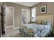 Cozy bedroom with natural light from the windows and en-suite bathroom entrance at 3582 Pete Dye Blvd, Carmel, IN 46033