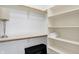 Bright walk-in closet featuring built-in shelves and a hanging rod for storage and organization at 3582 Pete Dye Blvd, Carmel, IN 46033