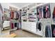 Bright walk-in closet with custom shelving, drawers and hanging rods providing ample storage space at 3582 Pete Dye Blvd, Carmel, IN 46033