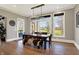 Dining room with hardwood floors, large windows, and modern chandelier at 3582 Pete Dye Blvd, Carmel, IN 46033