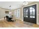 Elegant dining room featuring hardwood floors, stylish seating, and a view to the front entryway at 3582 Pete Dye Blvd, Carmel, IN 46033