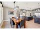 Open floor plan combines dining area and kitchen with stylish gray cabinets at 3582 Pete Dye Blvd, Carmel, IN 46033