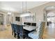Elegant dining room boasts stylish chandelier, table, and chairs with an archway leading to other spaces at 3582 Pete Dye Blvd, Carmel, IN 46033