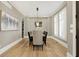 Well-lit dining room showcases hardwood floors, elegant seating, and a serene color palette for sophisticated dining at 3582 Pete Dye Blvd, Carmel, IN 46033