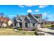 Charming two-story home with a stone and siding exterior, complemented by a well-manicured lawn and landscaping at 3582 Pete Dye Blvd, Carmel, IN 46033
