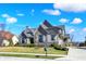 Attractive home featuring stone and siding, set on a well-kept lawn with established landscaping at 3582 Pete Dye Blvd, Carmel, IN 46033