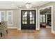 Inviting foyer with hardwood floors, a chandelier, and a view into a cozy, well-lit living space at 3582 Pete Dye Blvd, Carmel, IN 46033