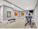 Home gym featuring exercise equipment, neutral carpeting, and modern decor for a complete workout space at 3582 Pete Dye Blvd, Carmel, IN 46033