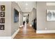 Spacious hallway leading to a living room showcases lovely wall art and wood flooring at 3582 Pete Dye Blvd, Carmel, IN 46033